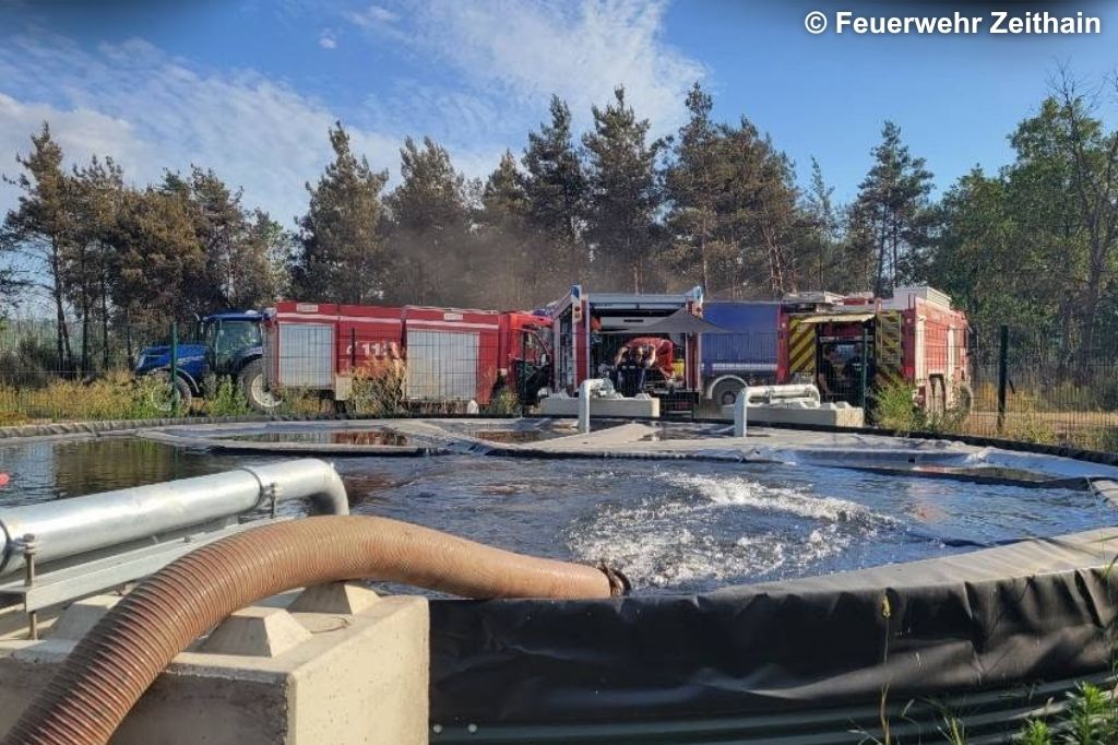 Feuerwehrfahrzeuge am Wasserbecken